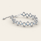 Flowing Cadence Bracelet with Blue Zircons in 18k White Gold