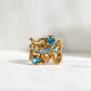 The Curve Ring with Blue Zircon in 18k Yellow Gold