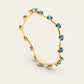 The Curve Bangle with Blue Zircons in 18k Yellow Gold